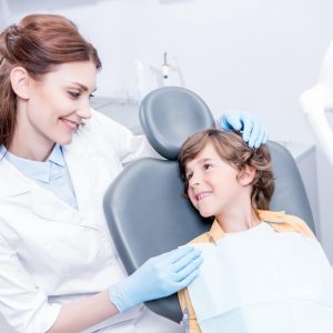 portrait of professional dentist and little boy in dentist office